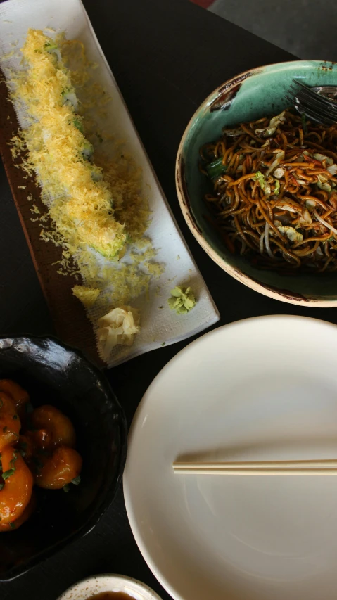 two plates with a spoon on one plate with fried food on the other