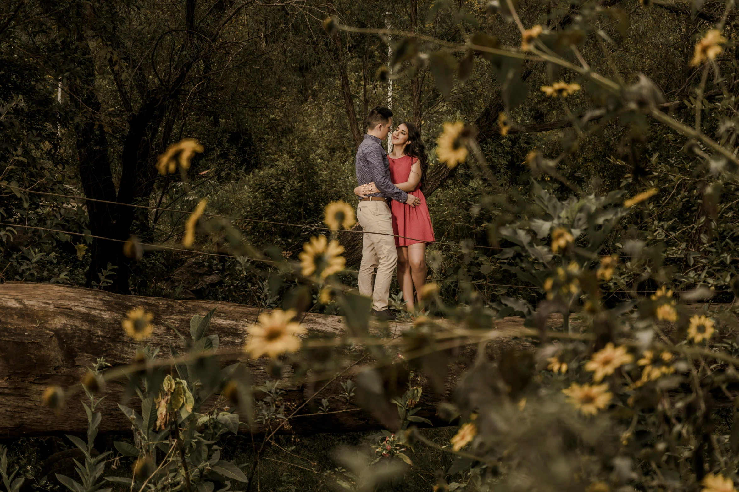 a couple is standing by the trees together