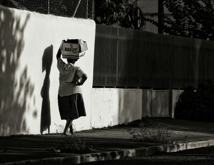 a man is standing under a light post