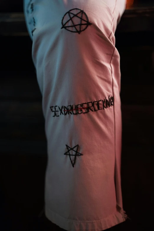 a close up of a shirt with pen and a pentagramter on it