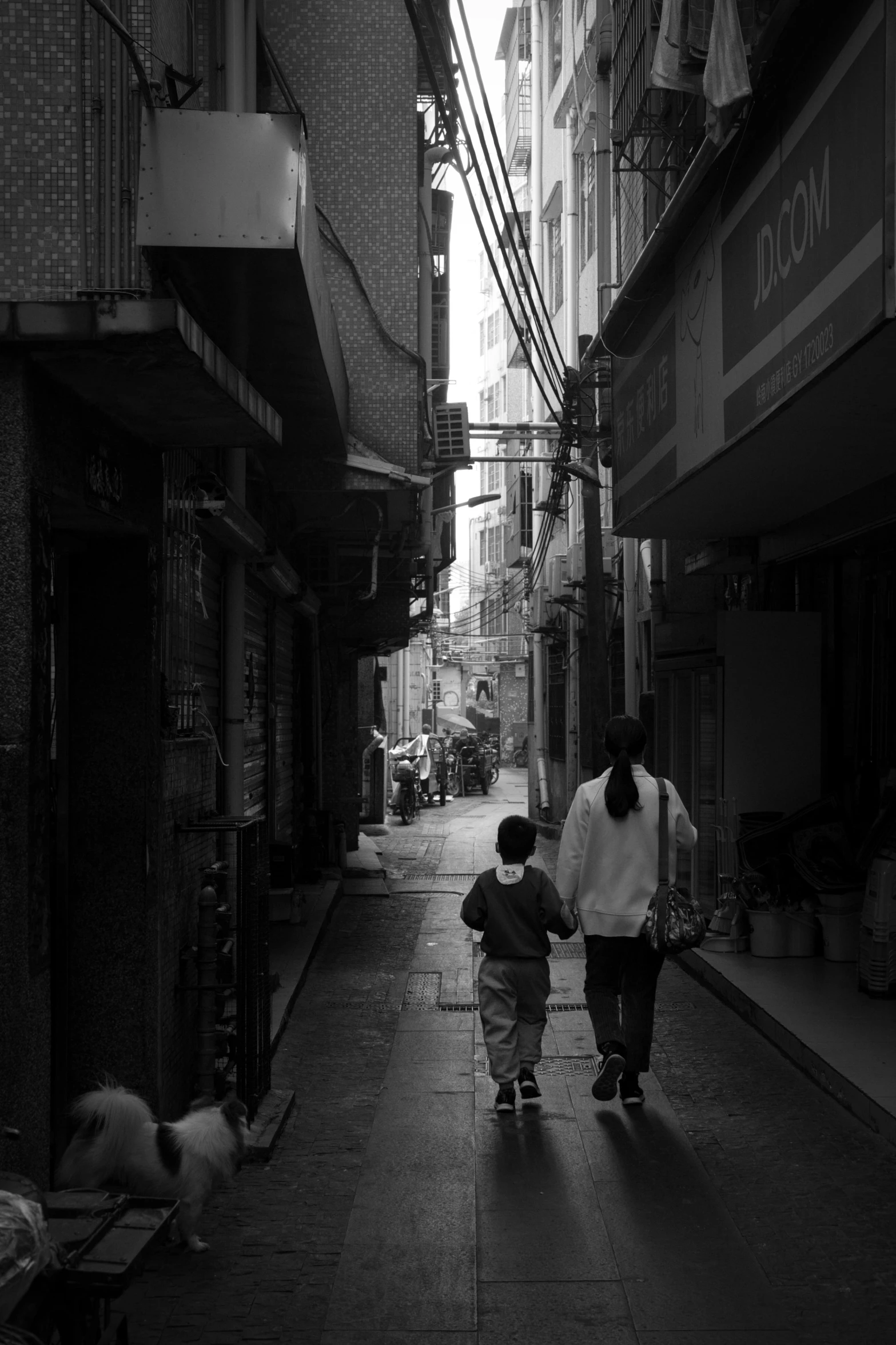 a mother and son walking down the street