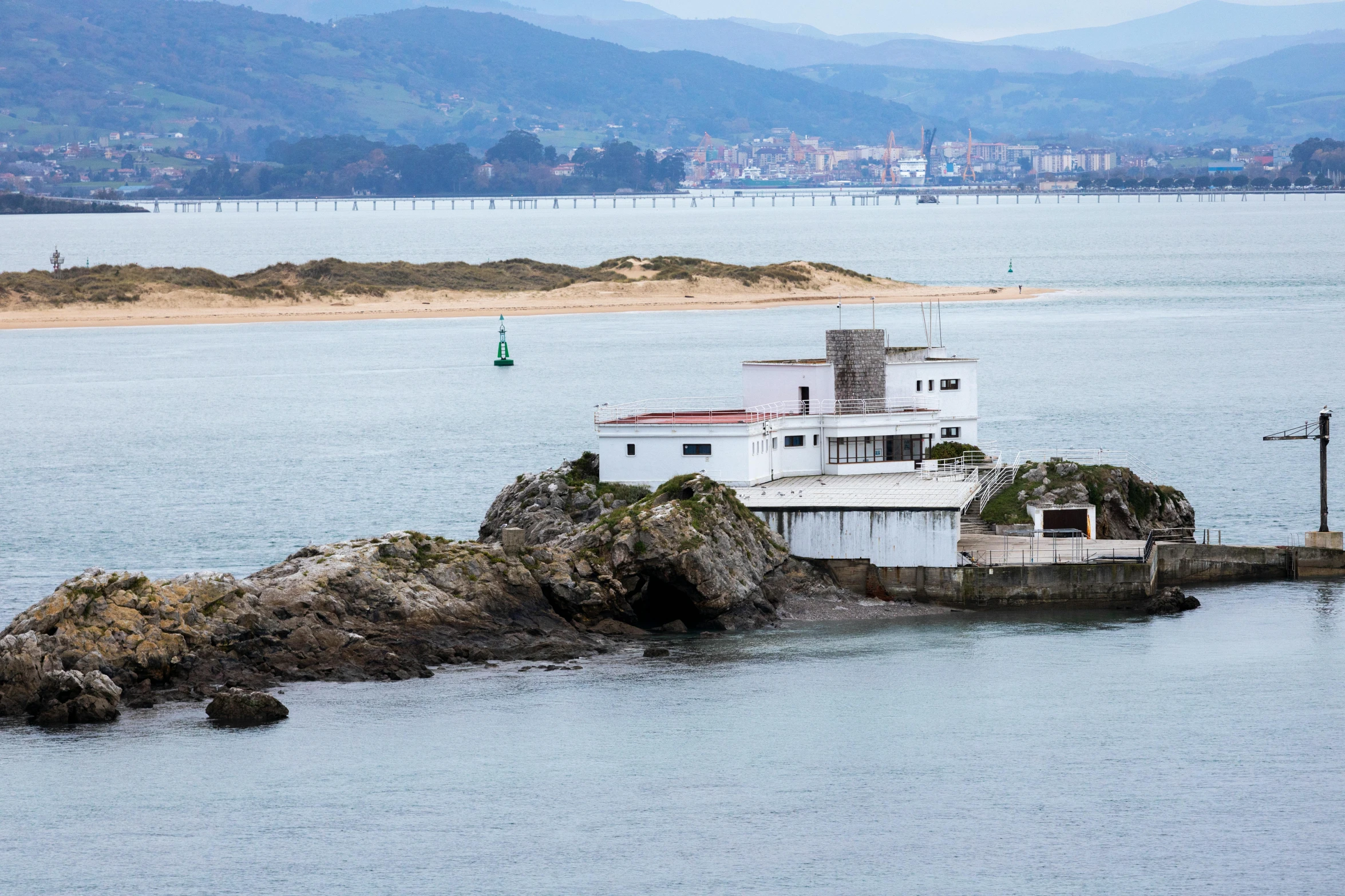 a house on a rock in the water