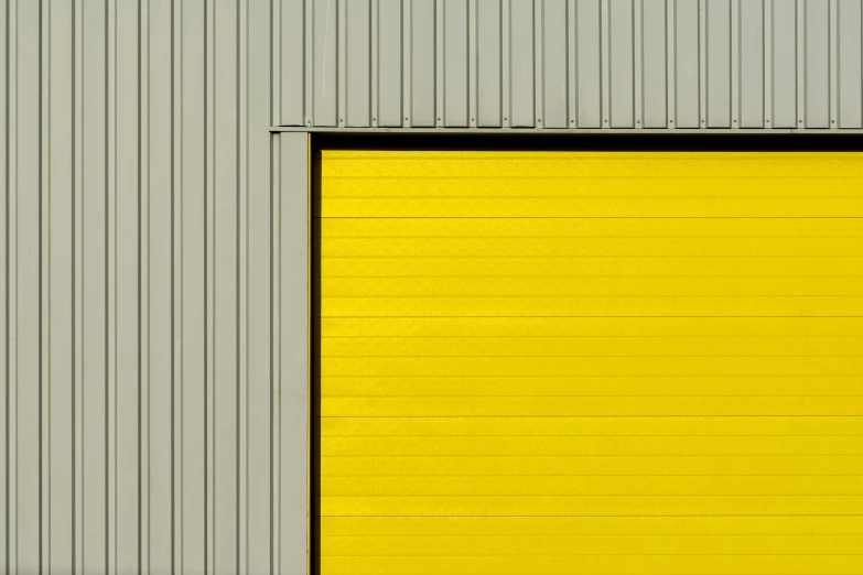 yellow door on a metal building with red fire hydrant