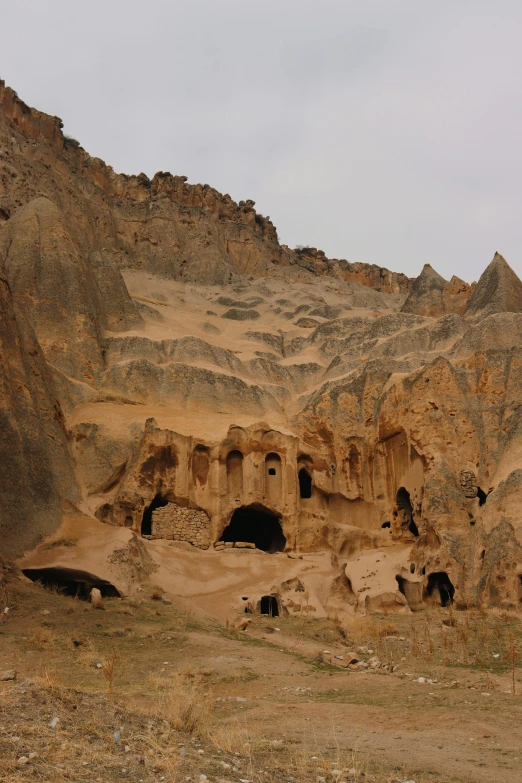 a rock formation with a hut in the middle