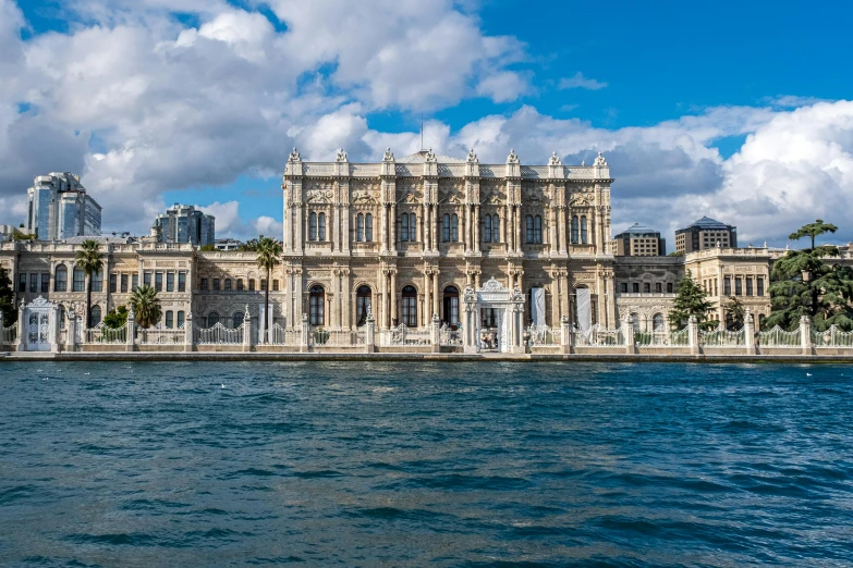 a large palace near the water on a sunny day