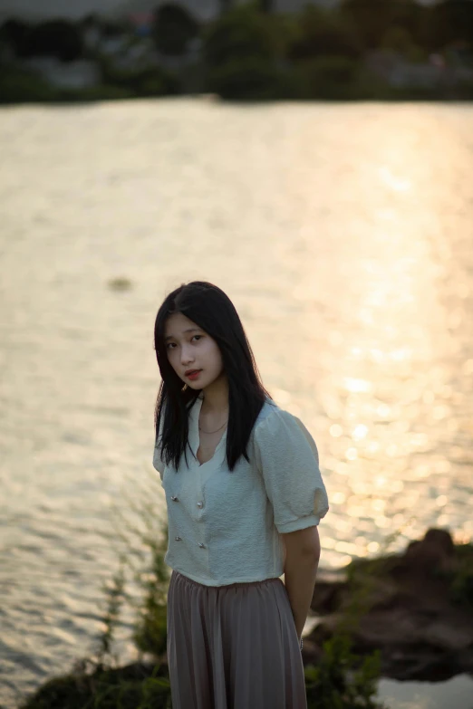 a woman that is standing in front of the water