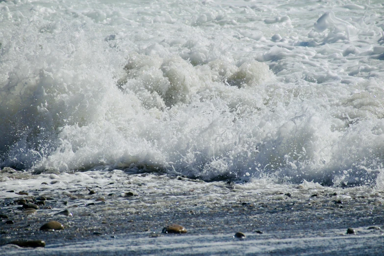 a beach scene with the water splashing around