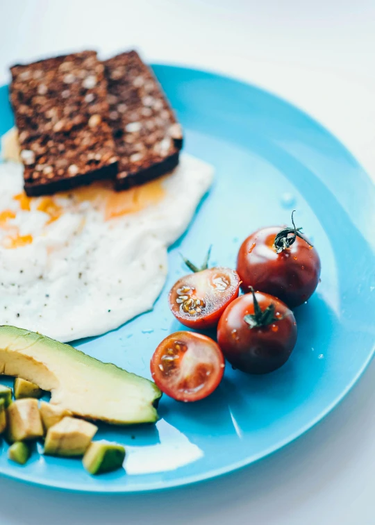 a blue plate filled with an assortment of food