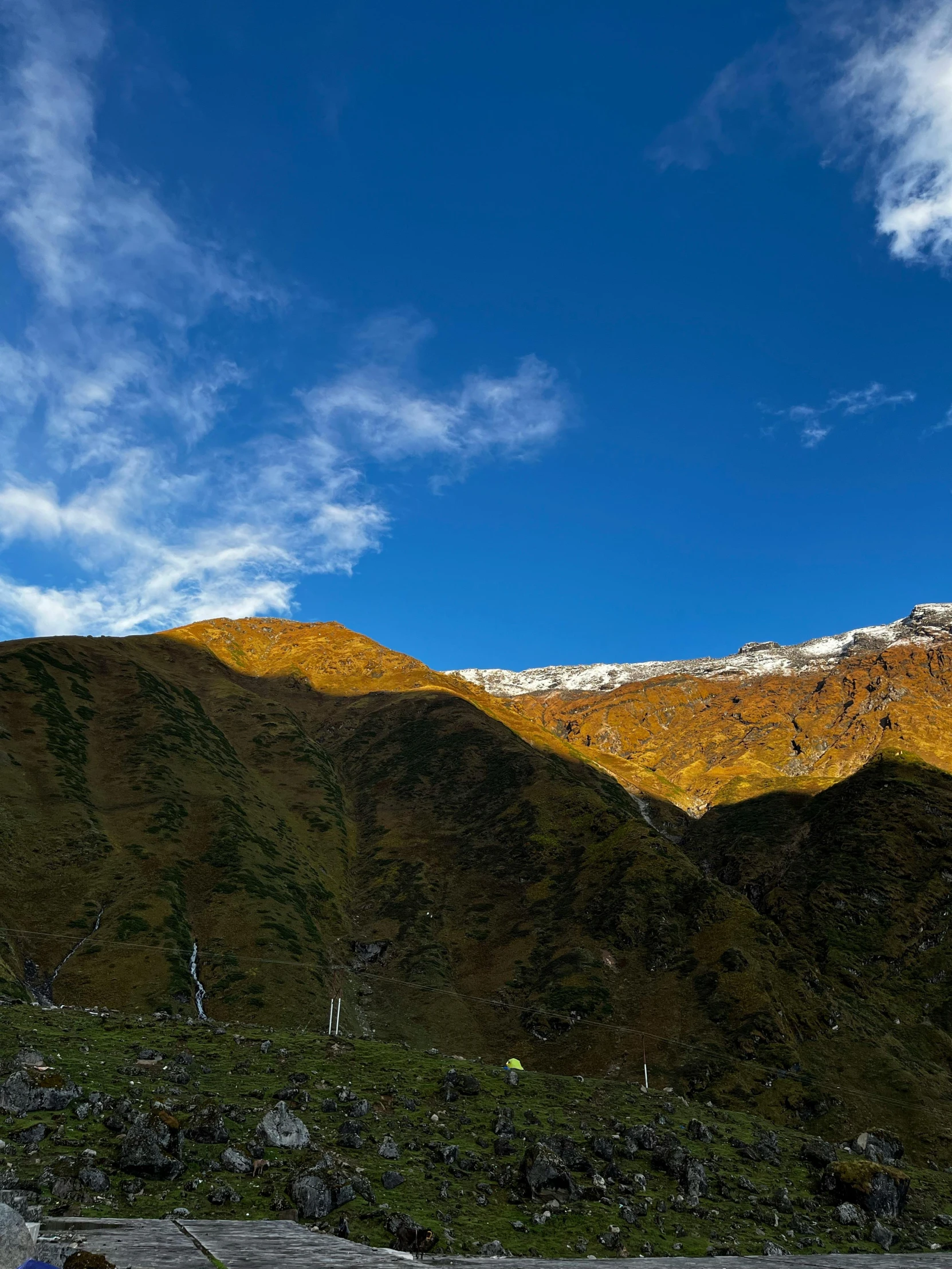 a snowy mountain range in the mountains under a blue sky