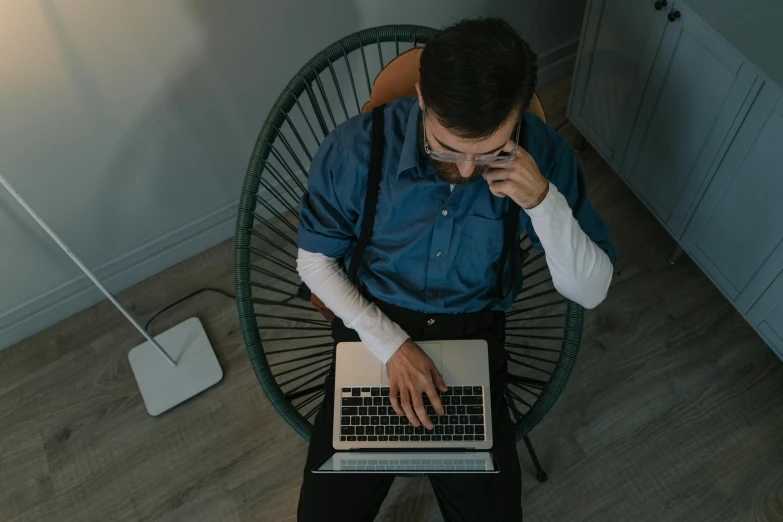 an overhead s of a man on a laptop