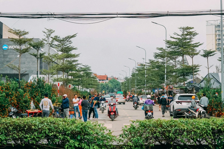 people walking on the sidewalk near traffic and cars