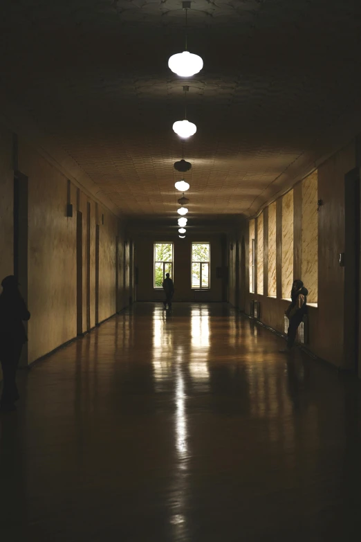 an empty long hallway is shown at night time