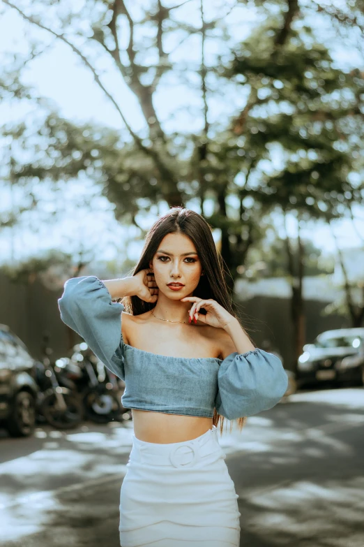 a young woman poses for a po while wearing white