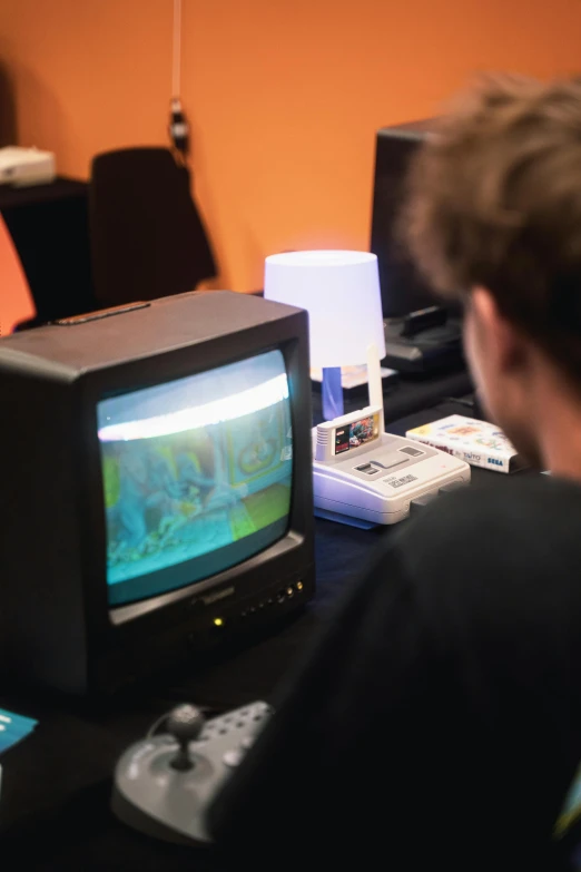 a person watches tv while using a computer