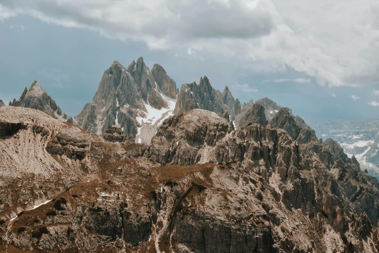 the view from a high point of a mountain range with lots of snow on the mountains