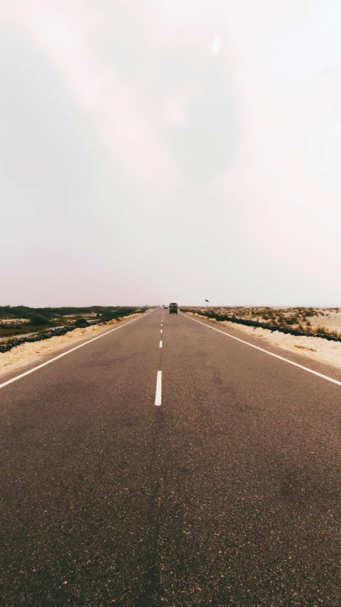 a street that is empty with a sky in the background