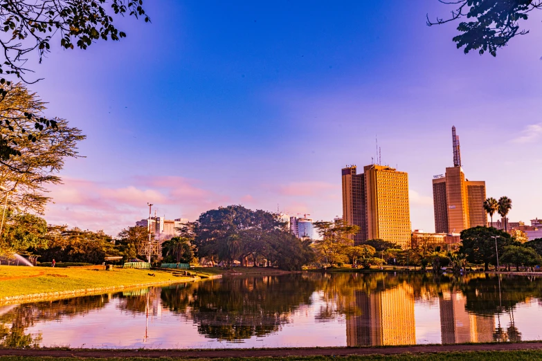 a city in the distance along a body of water with tall buildings