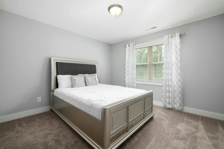 a large bedroom with an all white color scheme