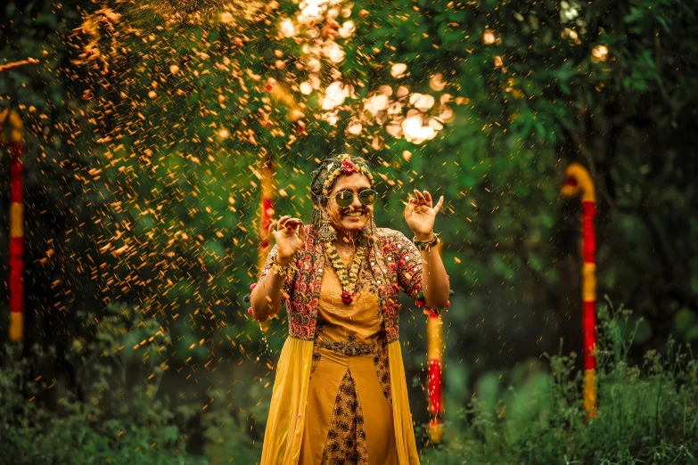 a man is celeting on a field with a fireworks show