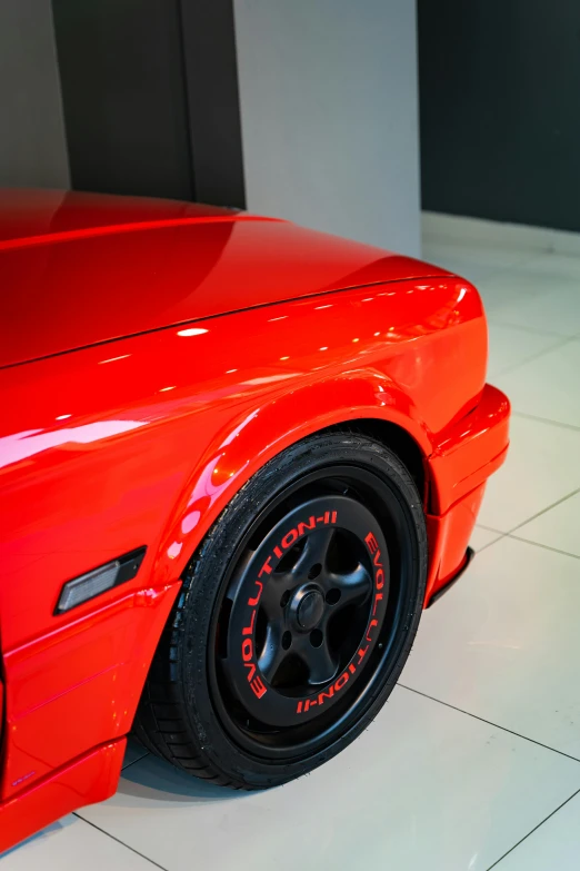 a car has a black rim with red detailing