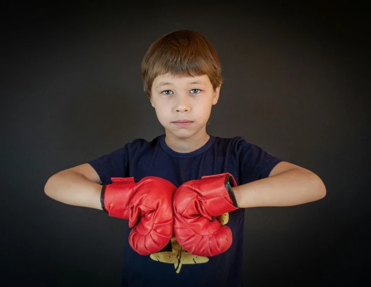  wearing red boxing gloves posing for po