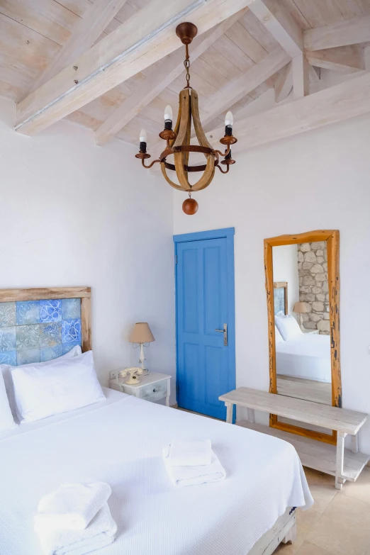 a bedroom with a big bed and blue door