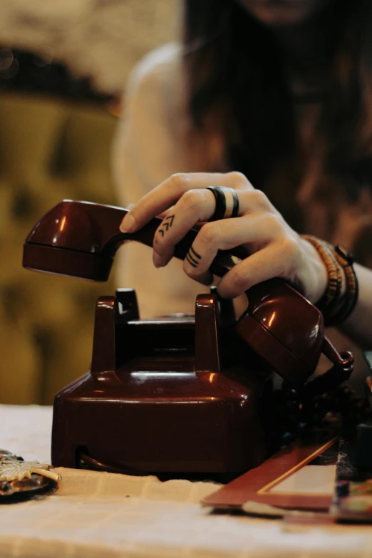 a woman uses an old fashioned rotary phone