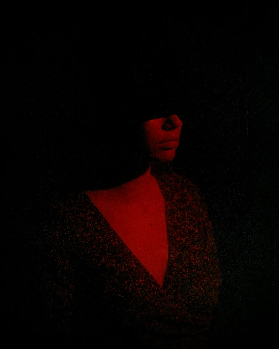 woman standing out at night with dark lighting in background