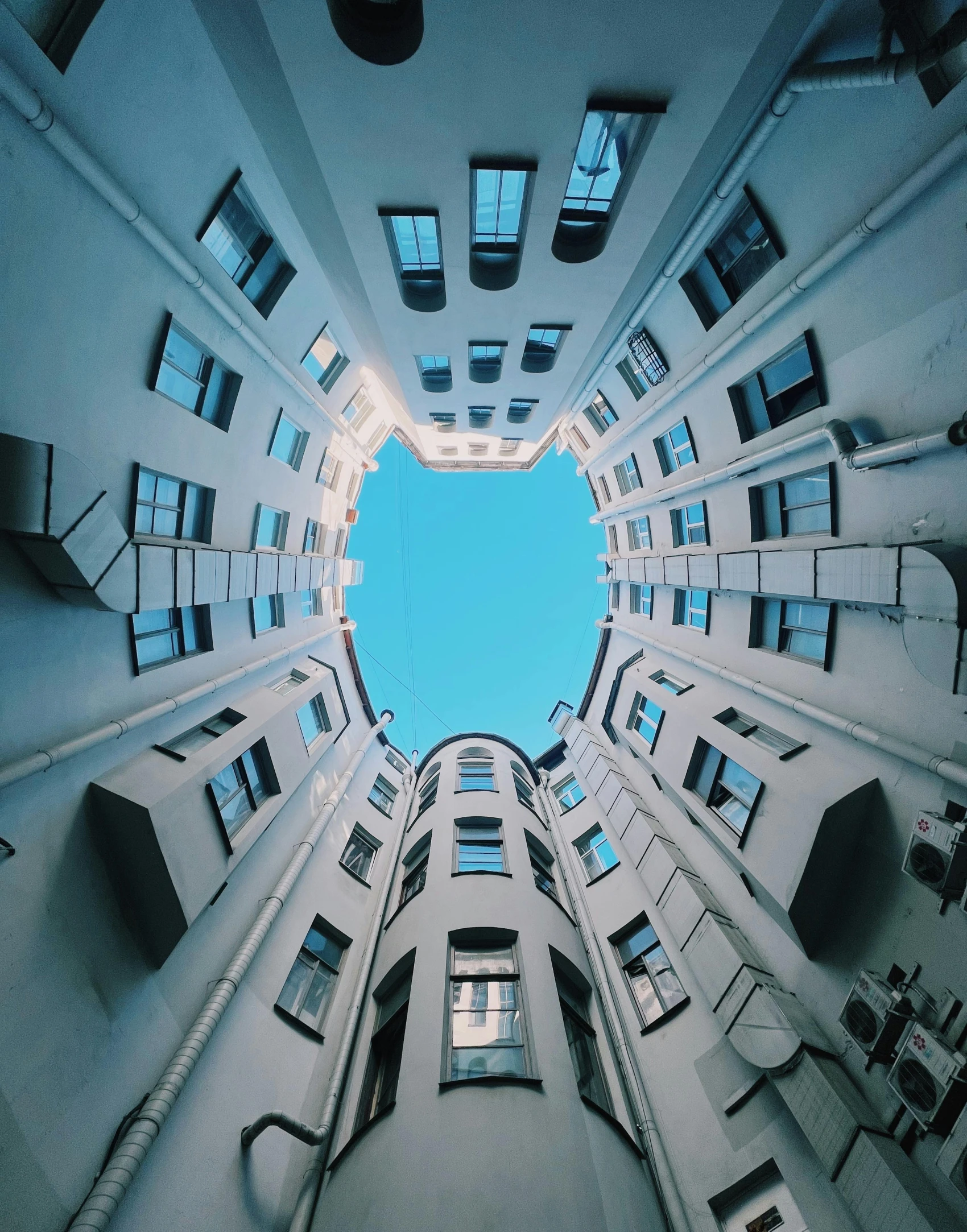 view from below of a tall building towards the sky