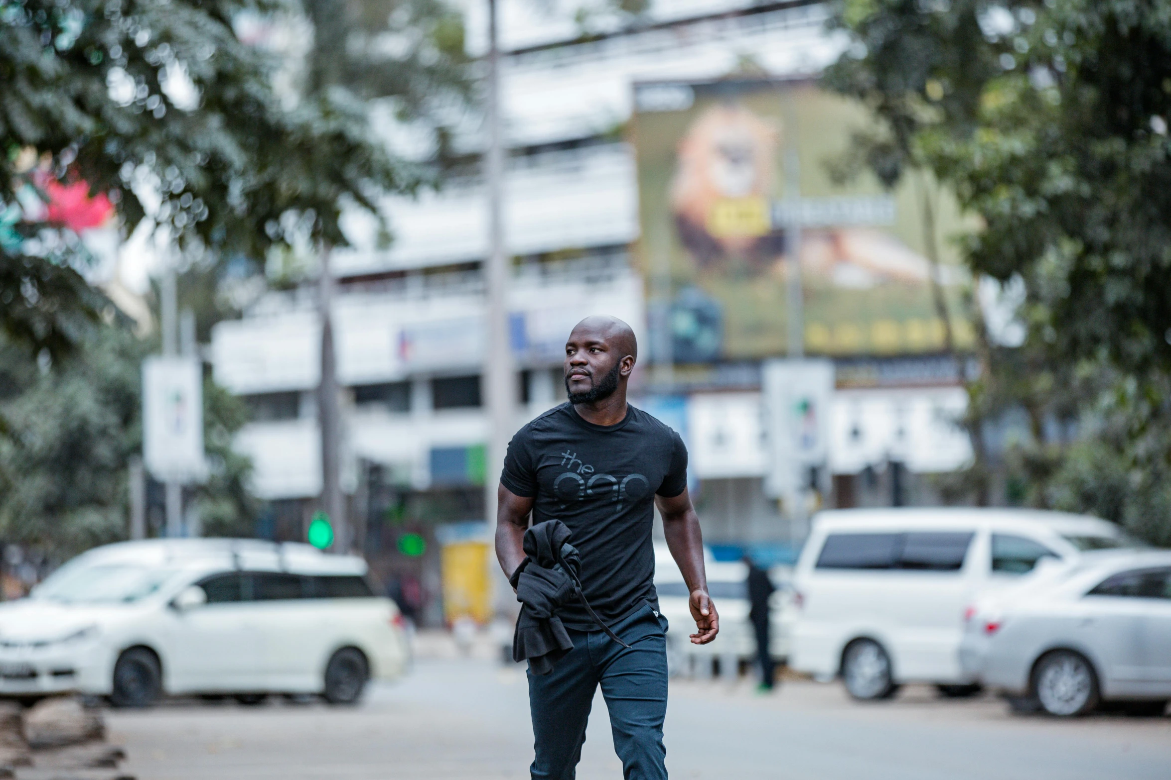 an african american man riding his skateboard on the street