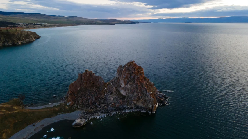 a large body of water with mountains in the distance