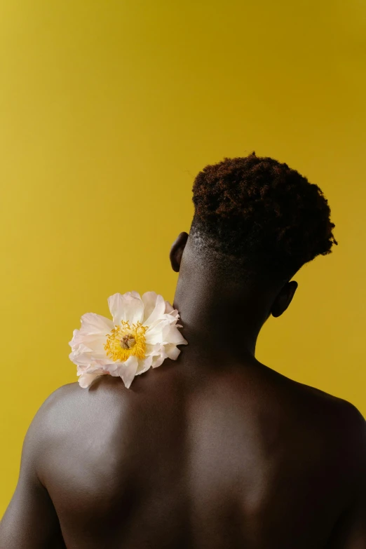 a man with a flower in his back