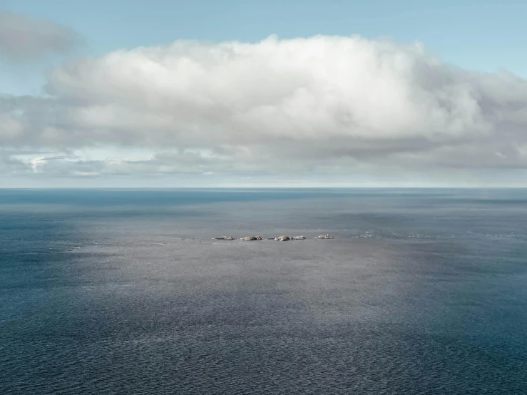 a large body of water under a cloudy sky