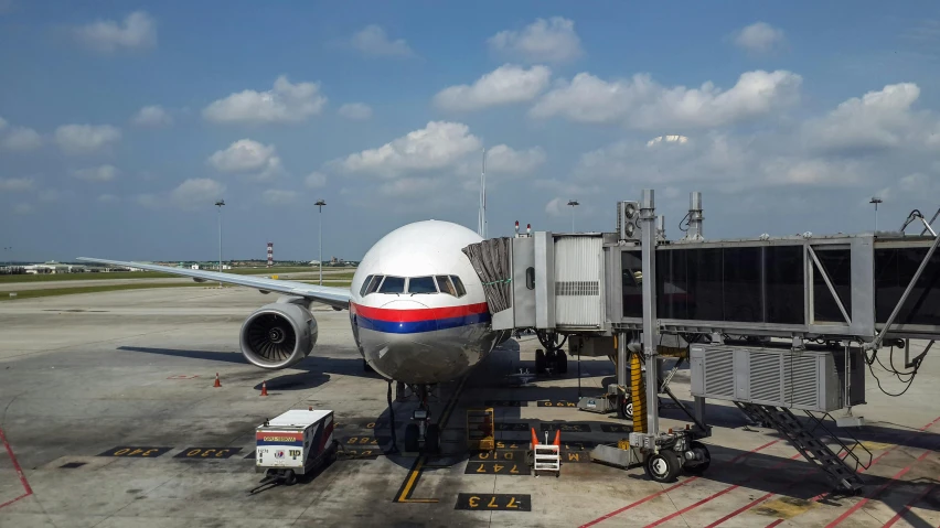 a plane parked on the tarmac with a ramp