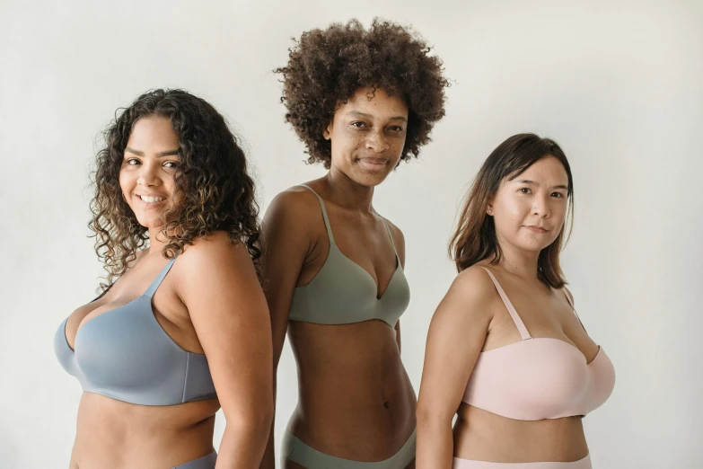 three women in sports s pose for the camera