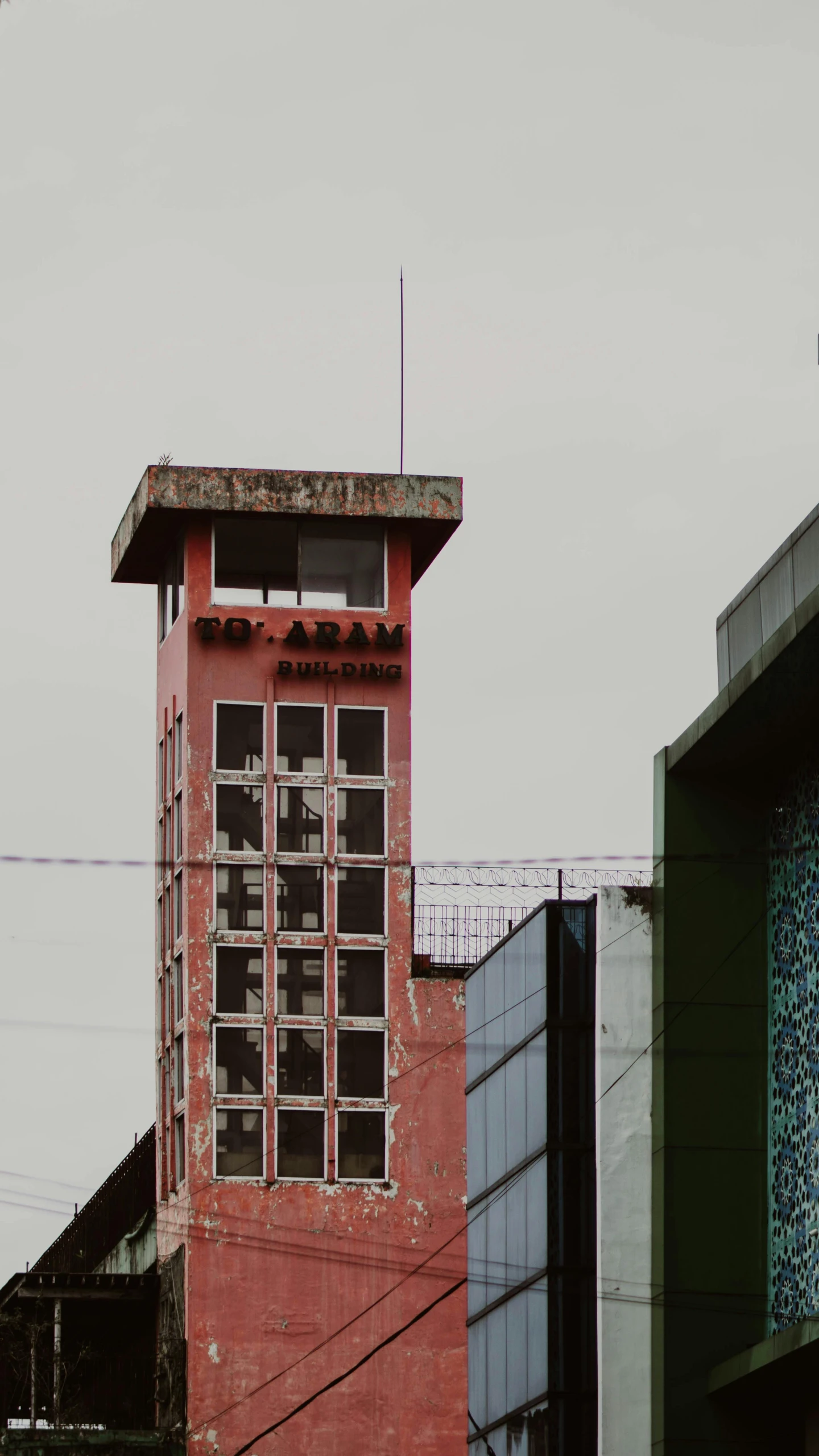 two buildings on the side of each other that have windows on each floor