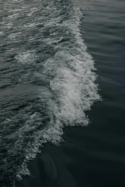 an ocean with small waves crashing into shore