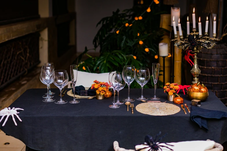 a table with glasses and candles in the center