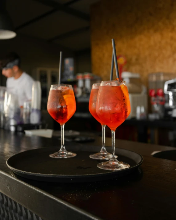 three wine glasses sitting on top of a table