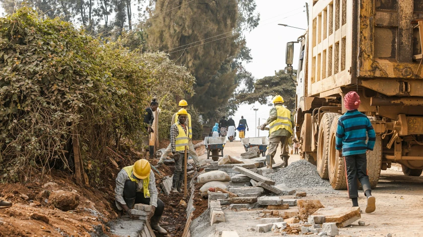 there are many construction workers working on this road