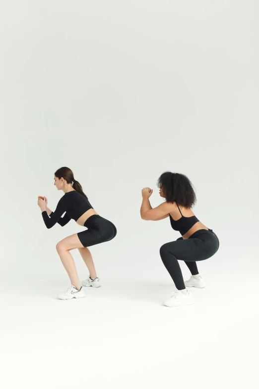 two women performing squats for a po