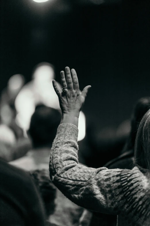 a child raising her hands up and listening to someone