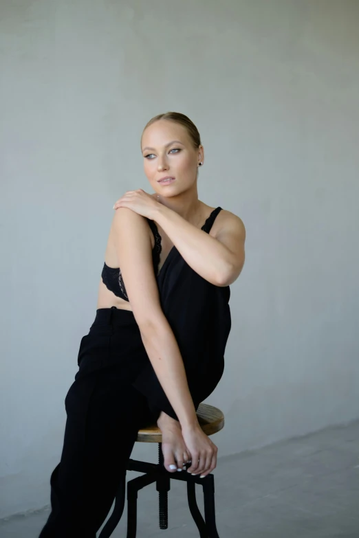 a woman sitting on top of a stool