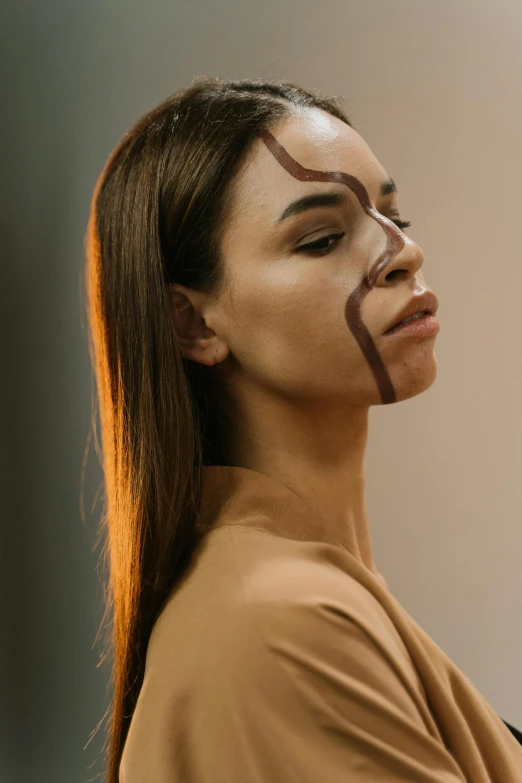 a woman with tape on her face and eyebrows