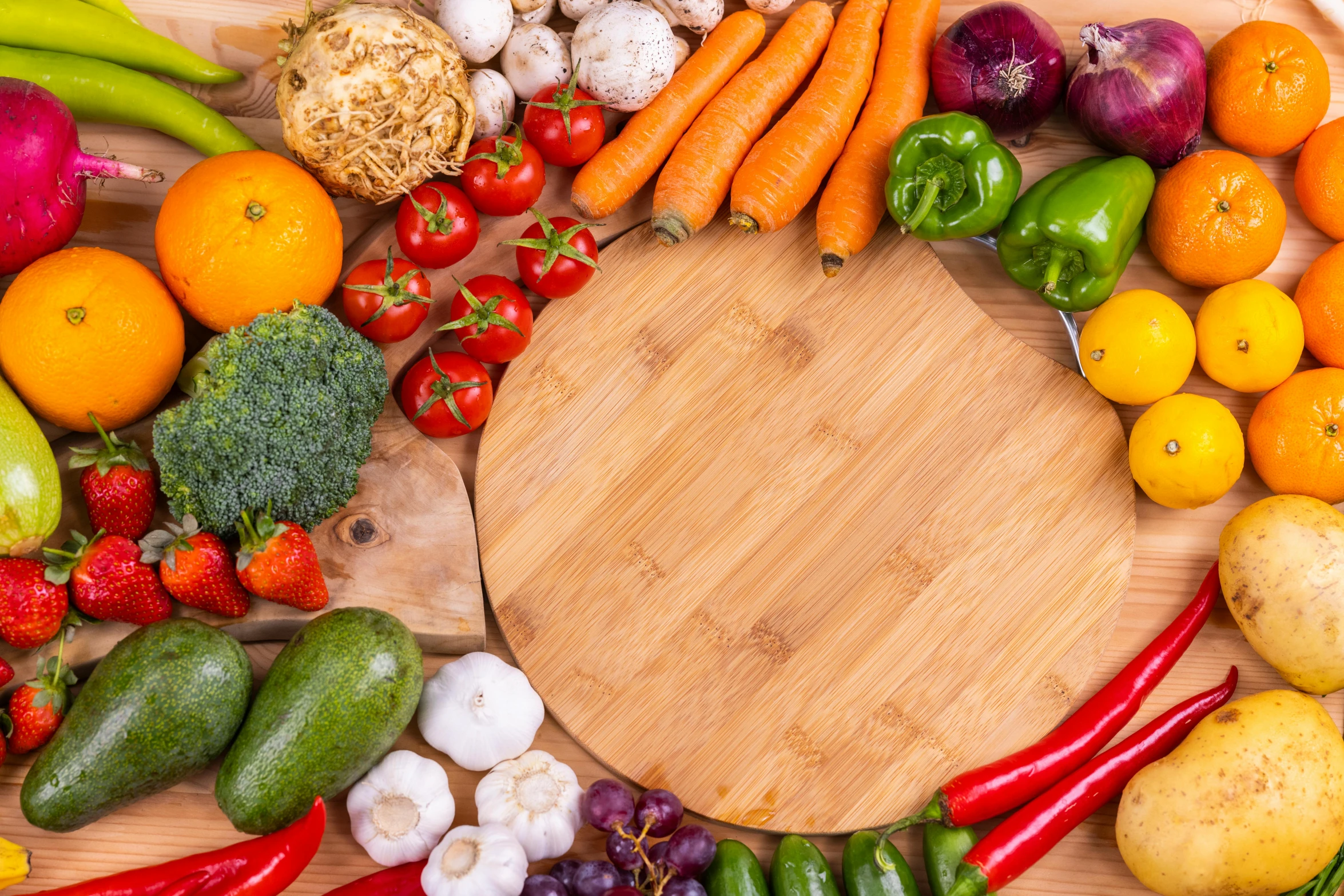 a bunch of food on a table that includes carrots, cucumbers, lemons, apples and gs