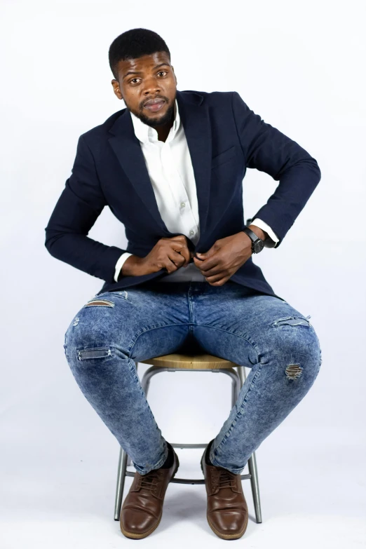 a man in a suit and tie sitting on a chair