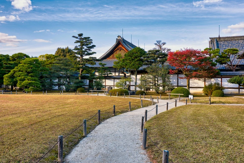 a path in front of a house between the grass