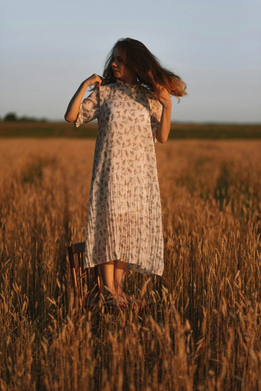 a woman with long hair in a field