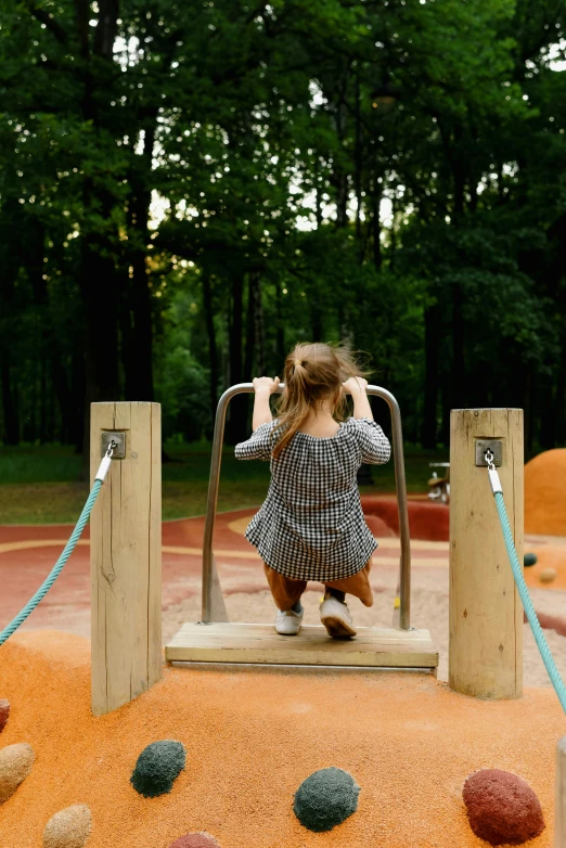 a little girl plays on a playground set