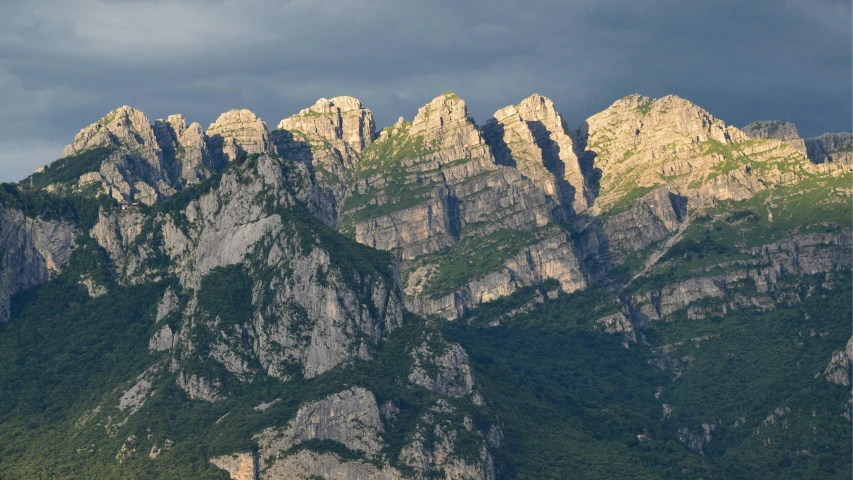 mountains and clouds, with the tops of two large rocks